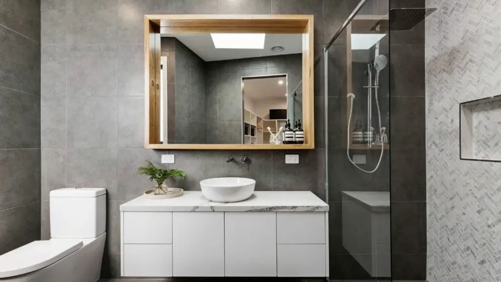 Small gray bathroom with tiled shower