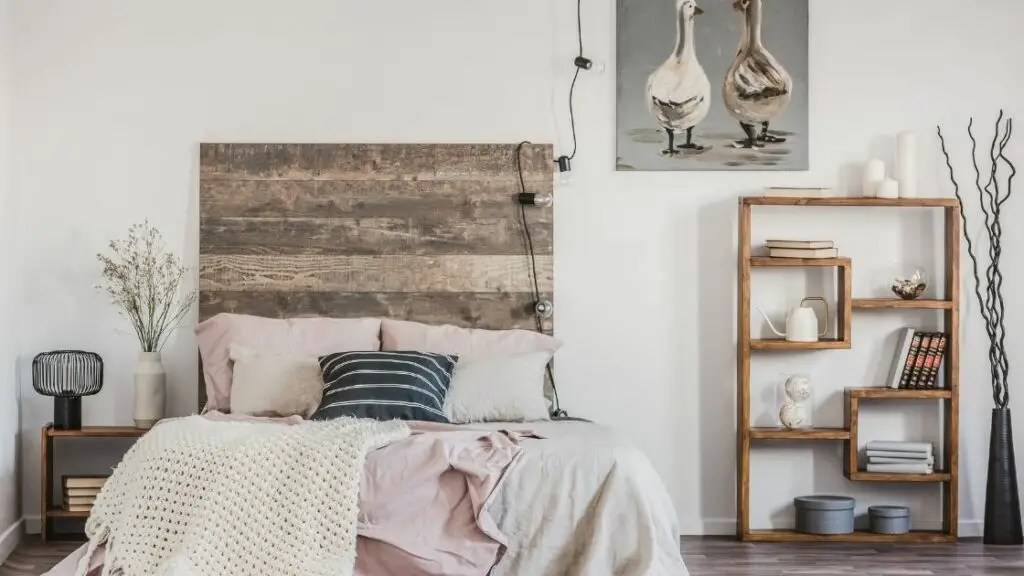 The tall wooden headboard is the feature of this room.  A string of lights adds to the rustic feel.