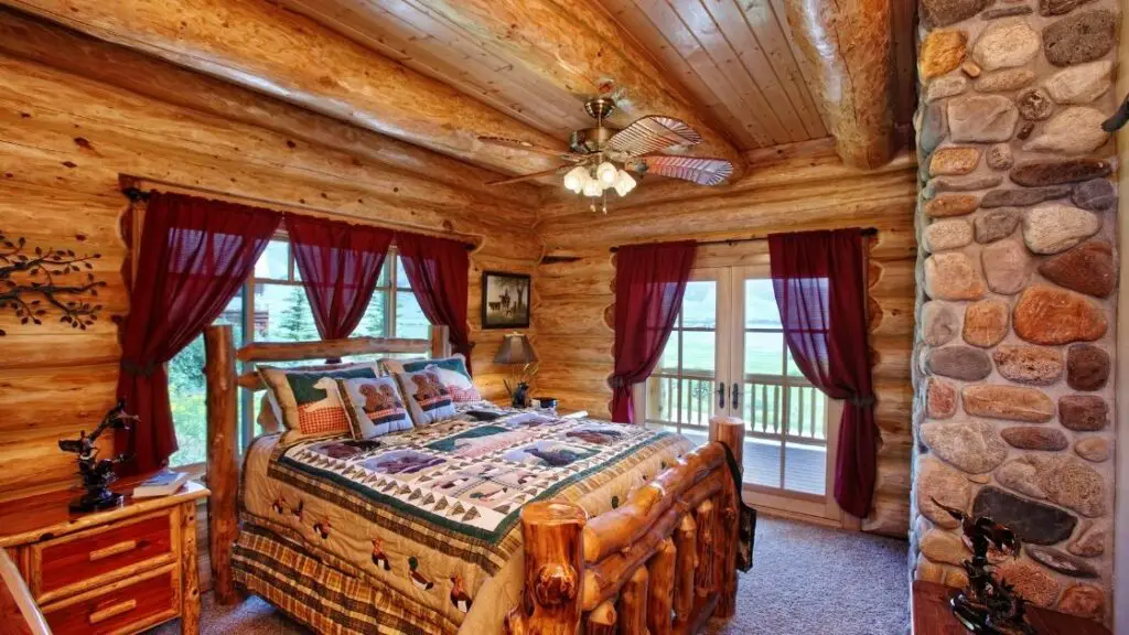 There is so much wood in this room.  The bed frame looks terrific, constructed from logs; it is the focal point of the room.  

