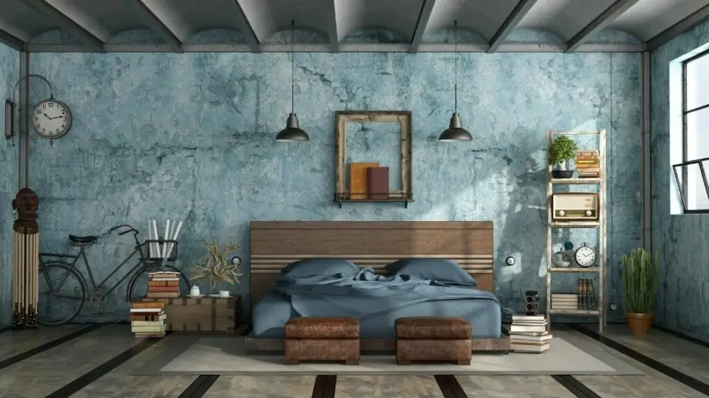 Bathed in natural light, this loft bedroom has a beautiful cool blue color theme, and the vintage decorations add to the rustic feel.