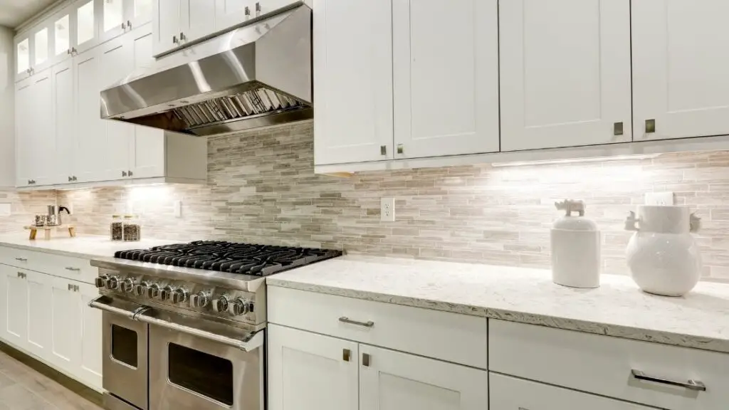 White and Gray Tiled Kitchen Backsplash White Cabinets