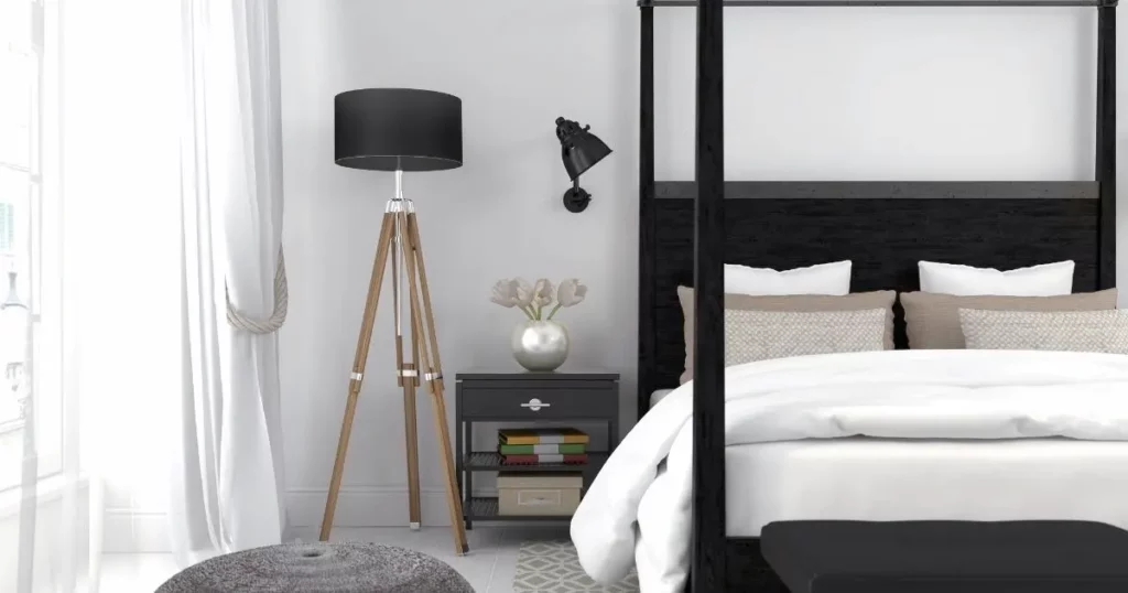 Black Bed with white sheets and walls